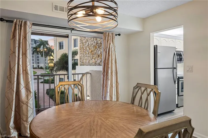Dining area featuring a chandelier and a textured ceiling