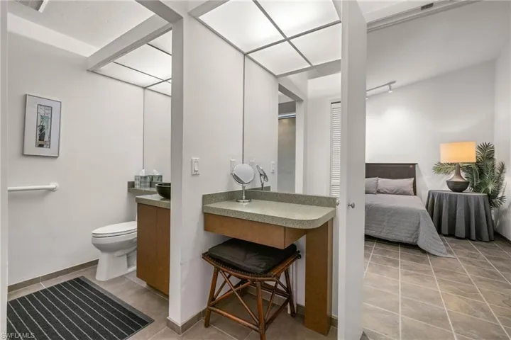 Bathroom with vanity, toilet, and tile patterned flooring