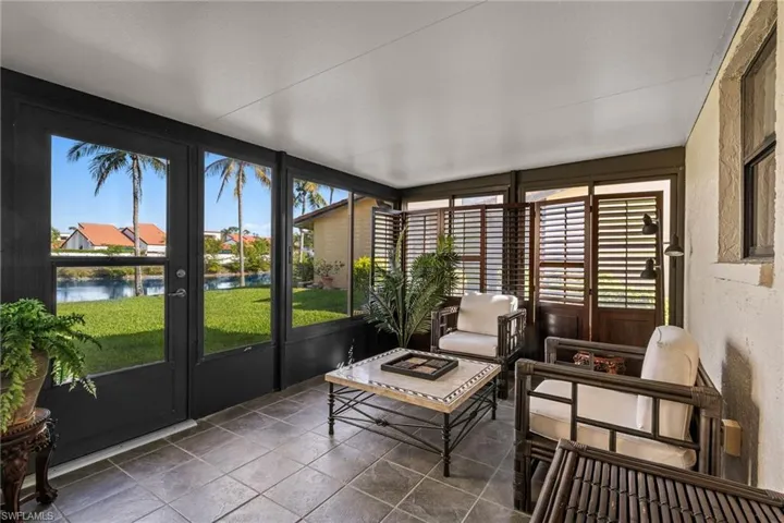 Sunroom / solarium featuring a water view and a healthy amount of sunlight