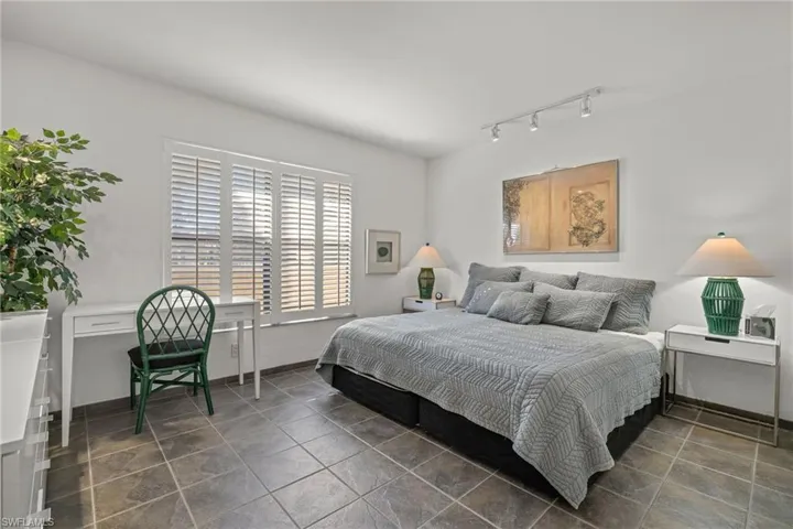 Bedroom featuring rail lighting