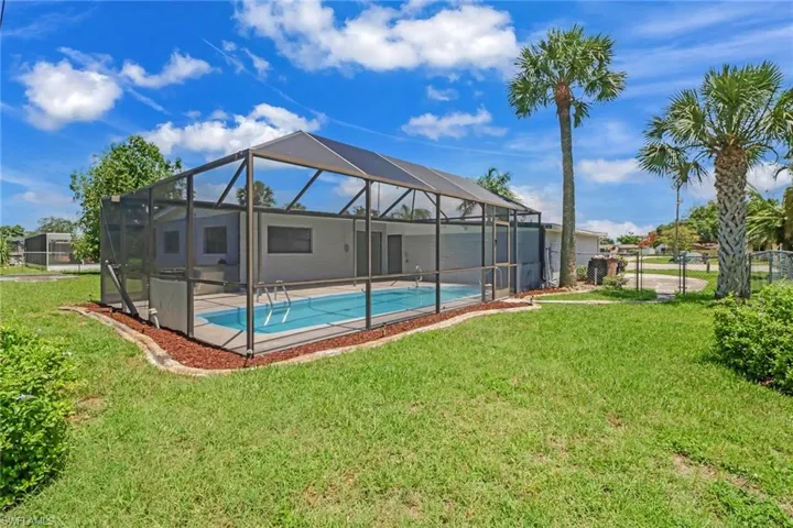 Back of House with In-Ground Pool & Pool Cage