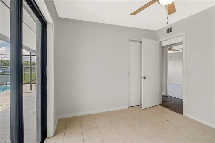 Bedroom 3 with sliding glass doors out to the pool