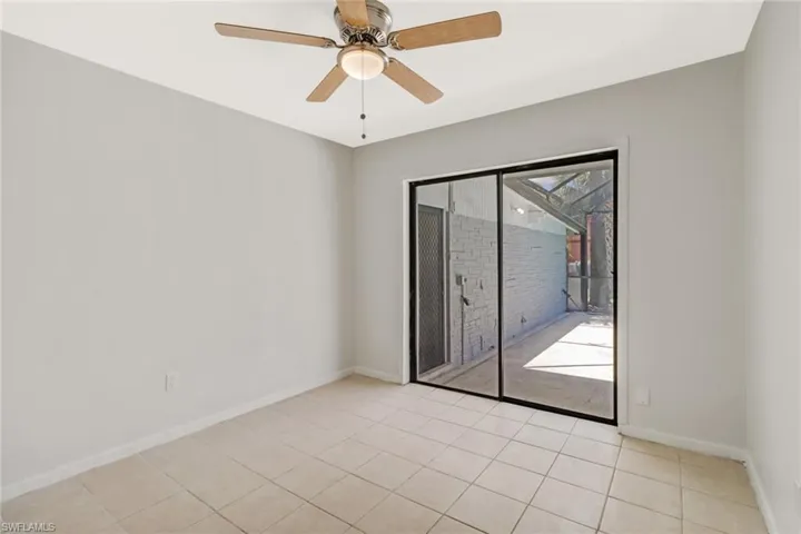 Bedroom 2 with sliding glass doors out to the pool