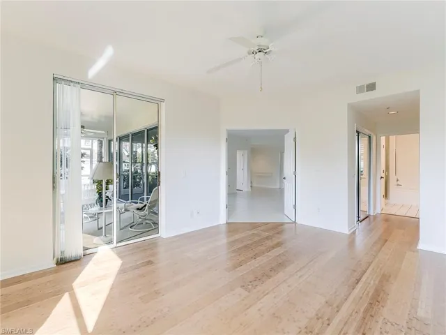 Spare room with a ceiling fan and light wood-type flooring