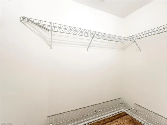 Walk in closet featuring wood finished floors