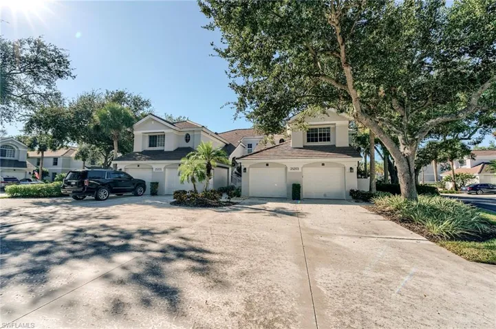 Traditional-style house featuring driveway, stucco siding, an attached garage, and a tiled roof