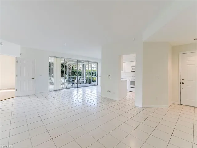 Spare room featuring light tile patterned floors and baseboards