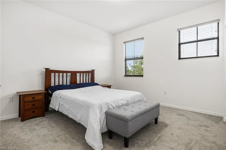 Bedroom with light colored carpet