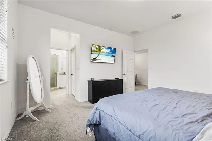 Bedroom with light colored carpet