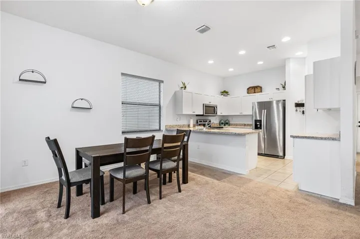 Dining area with light colored carpet