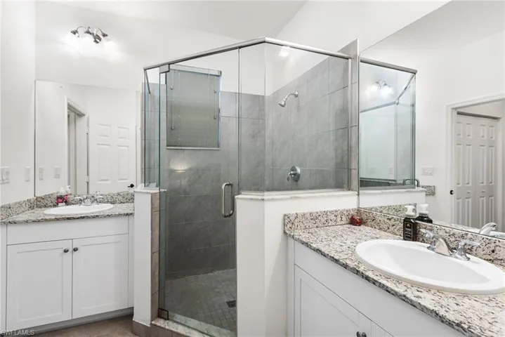 Bathroom with vanity, tile patterned flooring, and walk in shower