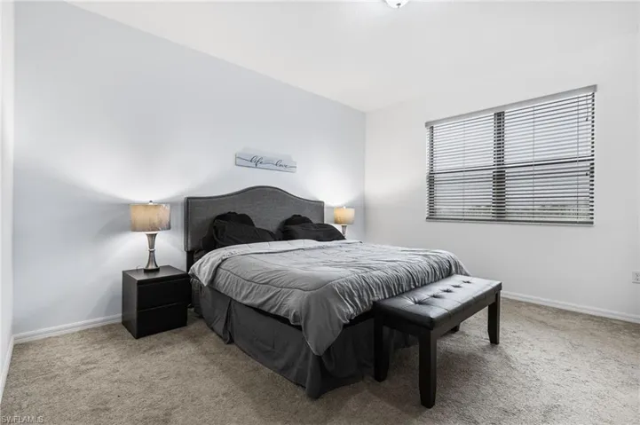 Bedroom featuring light colored carpet