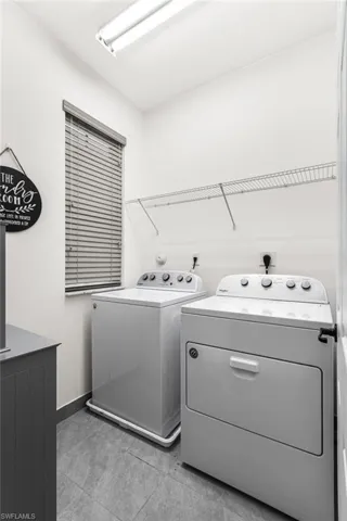 Clothes washing area featuring washer and clothes dryer