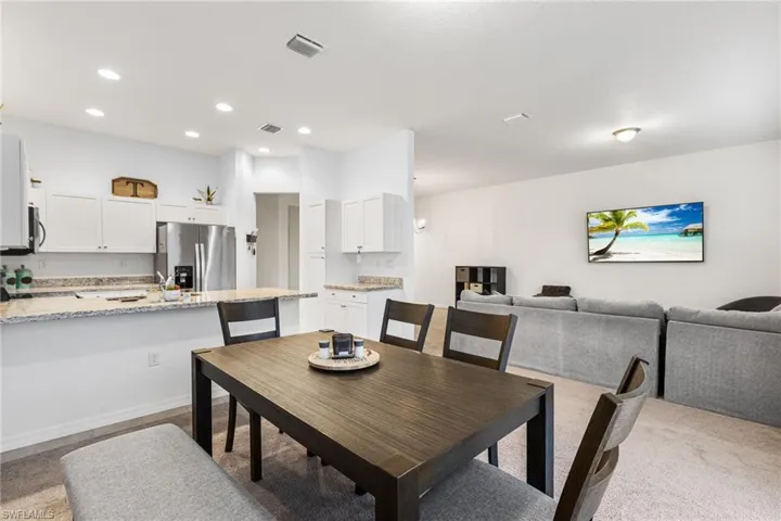 Dining area featuring light colored carpet
