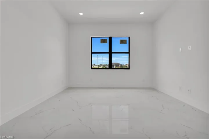 Unfurnished room with recessed lighting and light marble finish floors