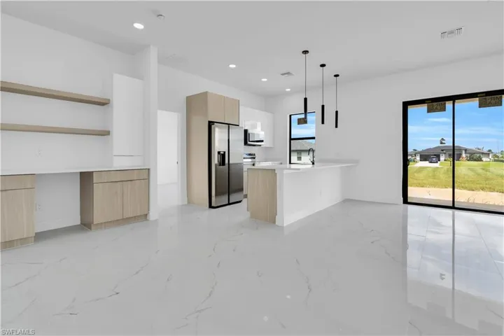 This room features light-colored walls and flooring, with a window providing natural light