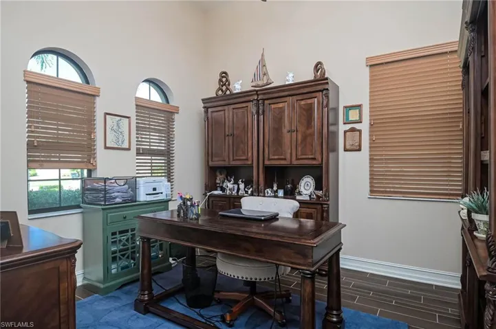 Office area with dark hardwood / wood-style floors