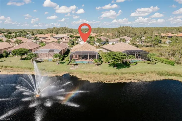 Birds eye view of property with a water view