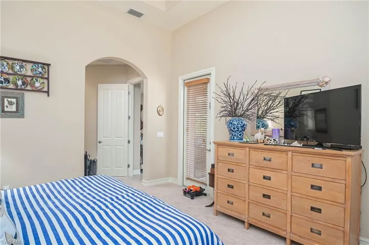 Bedroom featuring light colored carpet