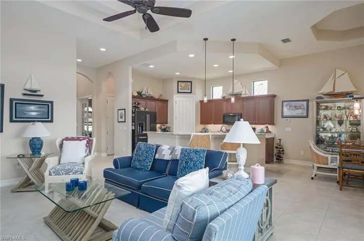 Living room featuring ceiling fan and light tile patterned floors