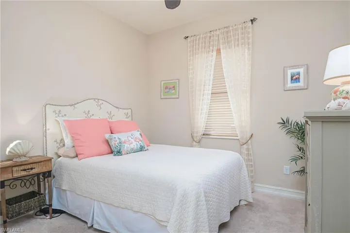 Bedroom featuring light colored carpet