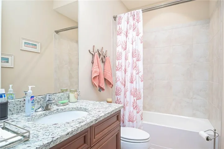 Full bathroom featuring shower / bath combo, vanity, and toilet