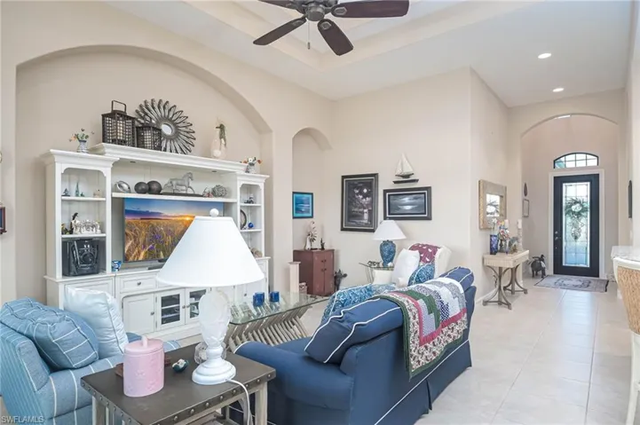Living room featuring ceiling fan and light tile patterned floors