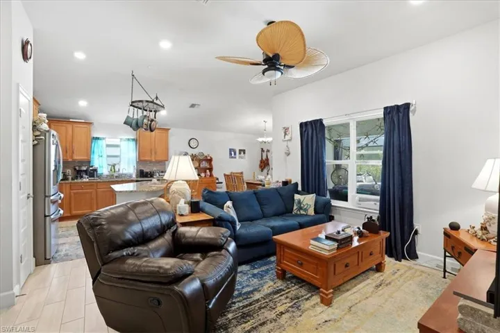 Living area featuring recessed lighting and a ceiling fan