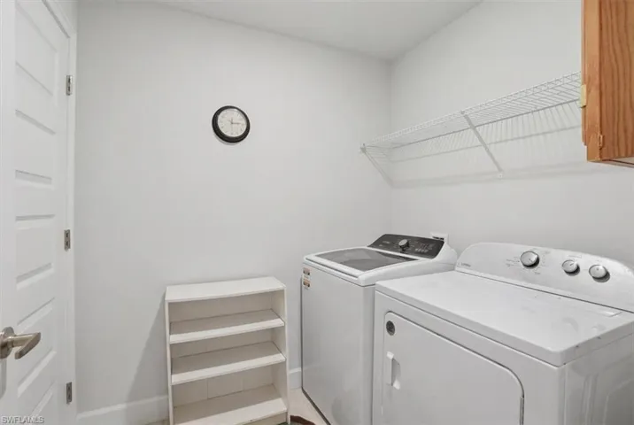 VIRTUALLY STAGED Laundry room with washing machine and dryer and cabinet space