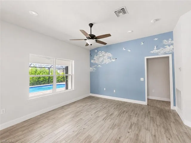 Wood-finish flooring, recessed lighting, and a ceiling fan with integrated light fixture