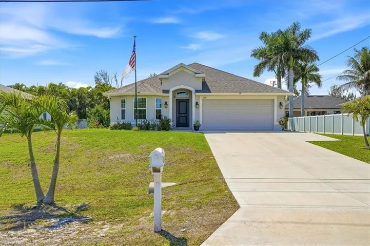 Ranch-style home with an attached garage, concrete driveway, stucco siding, and a shingled roof
