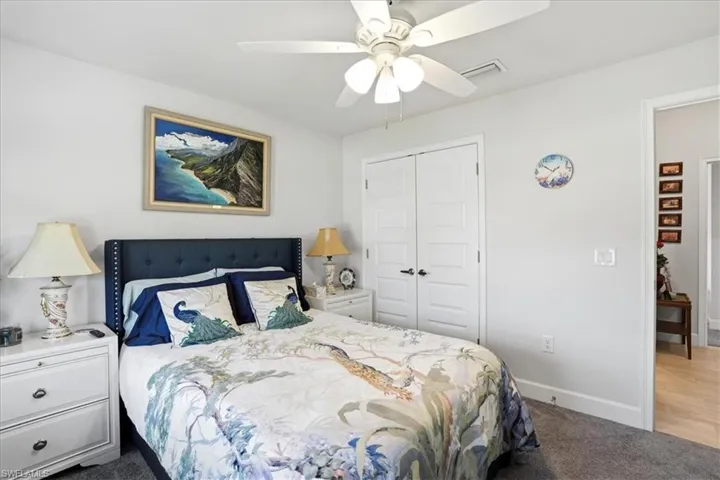 Bedroom featuring carpet, a closet, and a ceiling fan