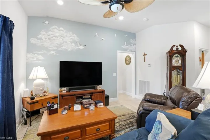 Living room with ceiling fan, recessed lighting, and light wood-style floors