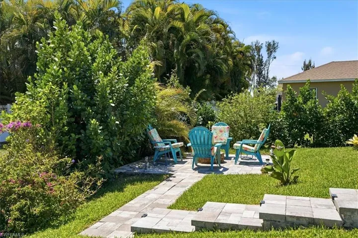 View of green lawn with a patio area