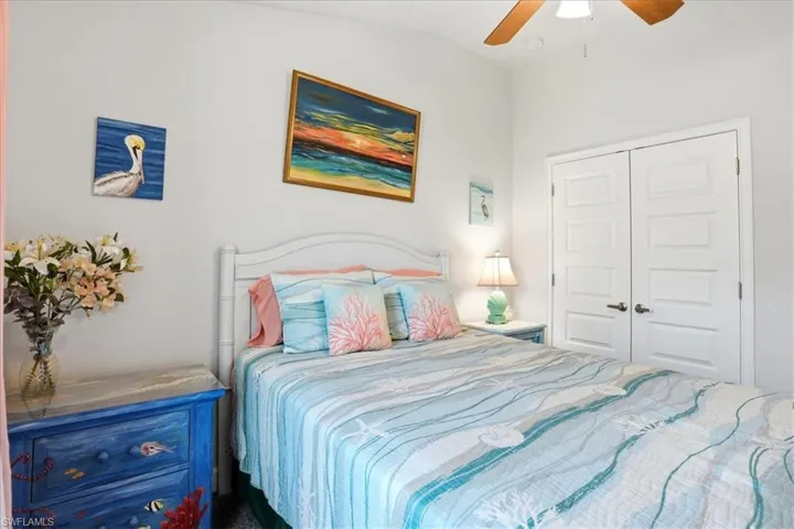 Bedroom with ceiling fan, a closet, and lofted ceiling