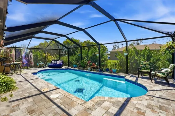 Outdoor pool with a sunroom, a lanai, and a patio area