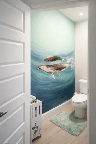 Bathroom featuring light wood-style flooring and baseboards
