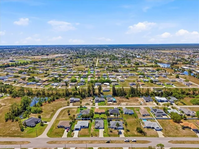 Aerial view of residential area featuring a nearby body of water
