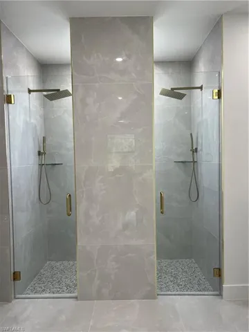 Full bathroom with a stall shower and tile patterned flooring