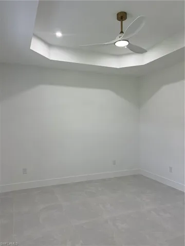 Spare room featuring baseboards and a ceiling fan