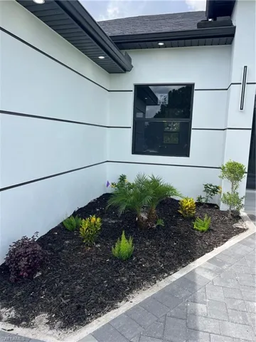 Exterior view of roof with shingles and stucco siding