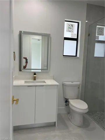Full bathroom with vanity and tiled shower