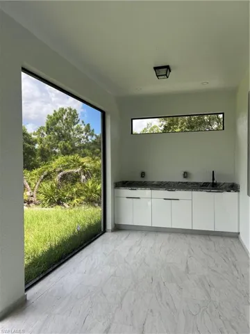Unfurnished sunroom featuring a sink
