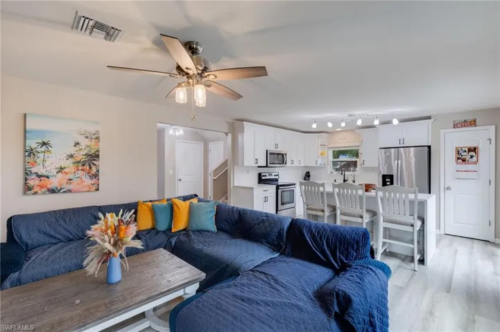 Living area featuring vinyl floors and ceiling fan