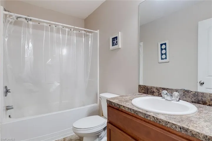 Guest Bathroom featuring vanity and shower / bath combo