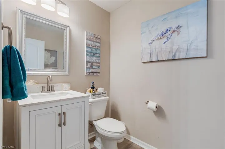 Half Bathroom featuring vanity downstairs