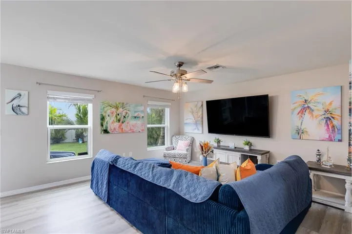 Living area with vinyl floors and a ceiling fan