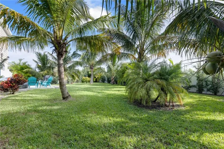 View of grassy yard featuring a patio area