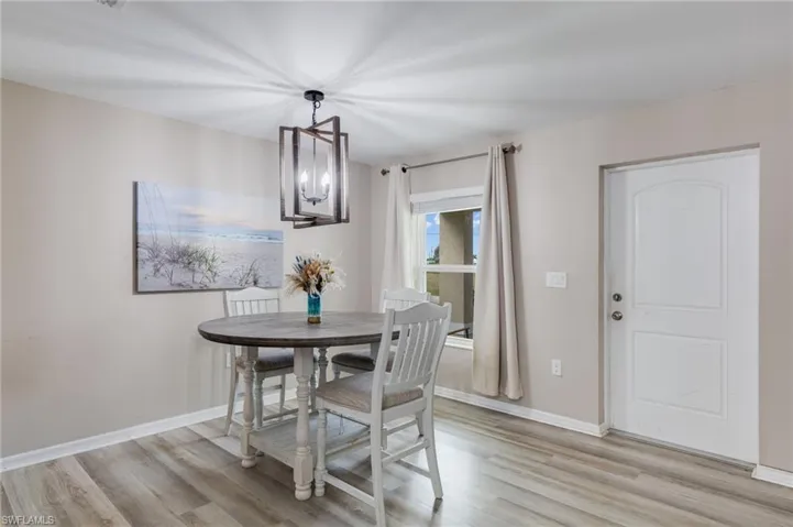 Dining room with vinyl floors and a chandelier