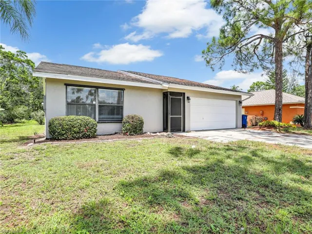 Ranch-style home with a garage and a front yard